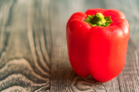 Large red bell paprika pepper on a cutting boardの写真素材