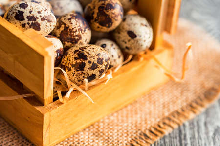Quail eggs on old brown wooden surfaceの写真素材
