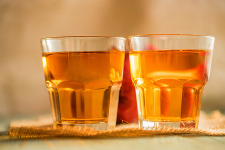 Fresh apple juice or cider in glasses on tableの写真素材