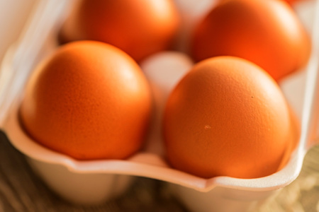 Fresh farm brown eggs on rustic backgroundの写真素材