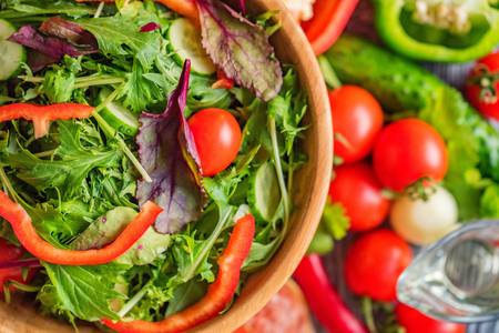 Fresh rustic vegetable salad on rustic backgroundの写真素材