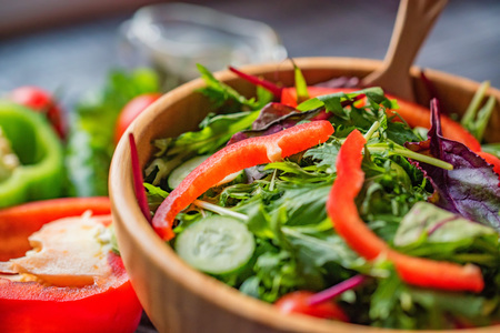 Fresh rustic vegetable salad on rustic backgroundの写真素材