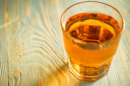 Glass of fresh apple juice or cider on wood tableの写真素材