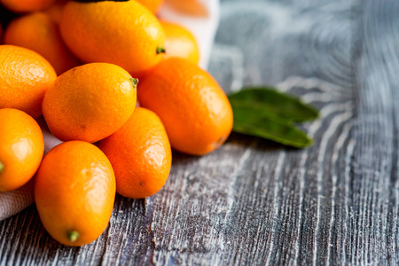 Kumquat or cumquat on wooden tableの写真素材