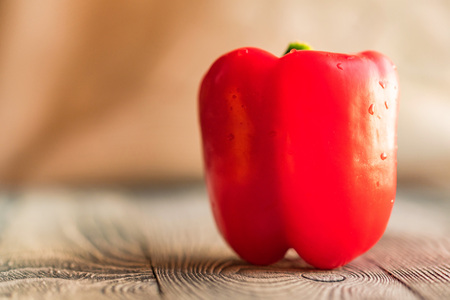 Large red bell paprika pepper on a cutting boardの写真素材