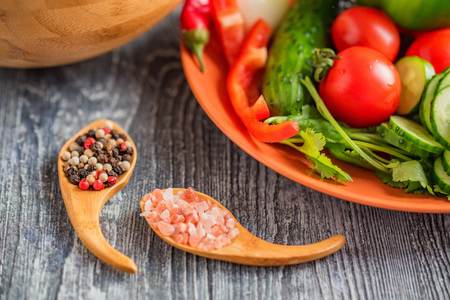 Fresh rustic vegetable salad on rustic backgroundの写真素材