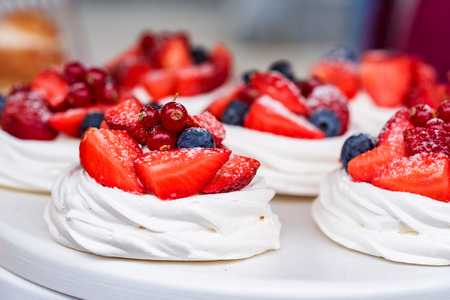 Meringue pastries with berries and fruitsの写真素材