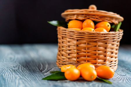Kumquat or cumquat on wooden table