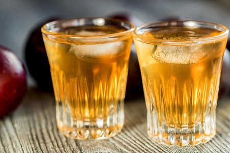 Plum brandy or slivovitz with fresh and tasty plumの写真素材