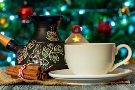 Cozy winter setting with cup of coffee and cezvaの写真素材