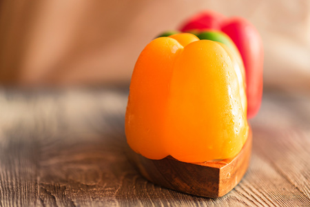 Variety of bell paprika peppers on cutting boardの写真素材