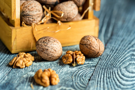 Walnuts in box on wooden backgoundの写真素材