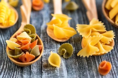 Various mix of pasta on wooden rustic backgroundの写真素材