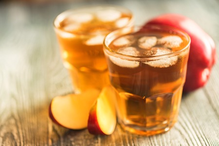 Fresh apple juice or cider in glasses on table