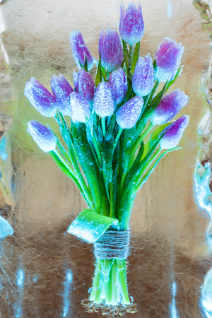 Decorative bunch of tulips in iceの写真素材