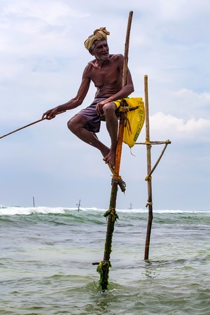 WELIGAMA, SRI LANKA - CIRCA DECEMBER 2013: Stilt fishermanのeditorial素材