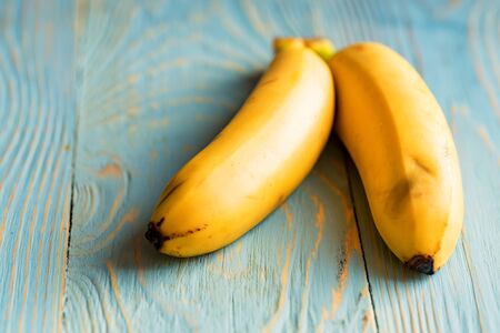Pair of bananas on wooden backgroundの写真素材