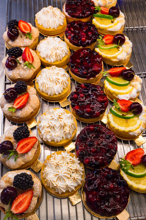 Dessert tartlets with fruit and berries top view