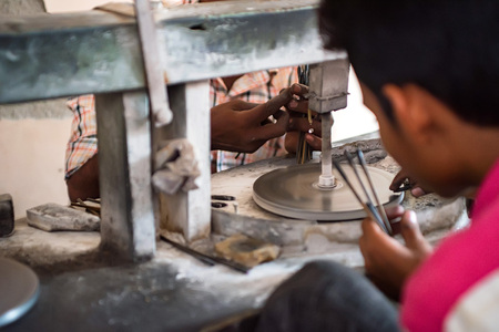 Hand of craftsman holds several stone cuttersの写真素材