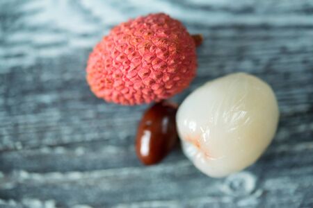 Two lychee fruits wooden backgroundの写真素材