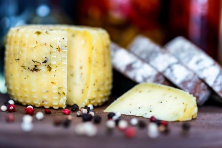 Rustic cheese with herbs, rye bread and peppercornの写真素材