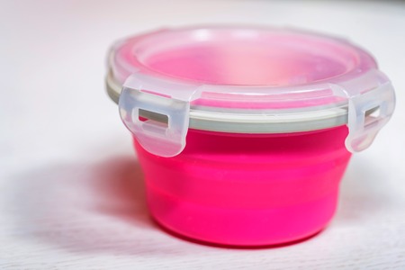 Bright plastic baby dishes on table