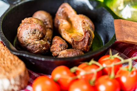 Tasty roasted chicken giblets in pan and rye breadの写真素材