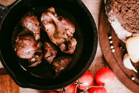 Top view roasted chicken giblets in pan and breadの写真素材