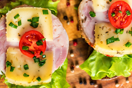 Sandwiches with cheese, turkey, lettuce and tomatoの写真素材