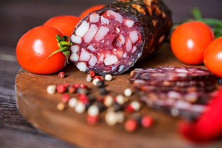 Tasty salami with tomatoes and peppercorn closeの写真素材