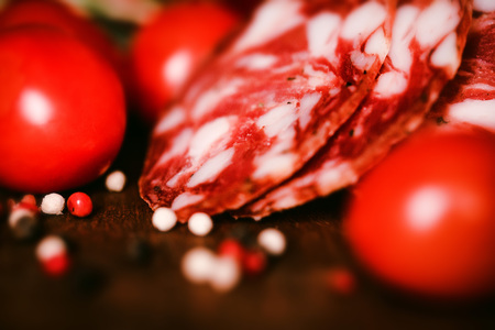 Tasty salami with tomatoes and peppercorn closeの写真素材
