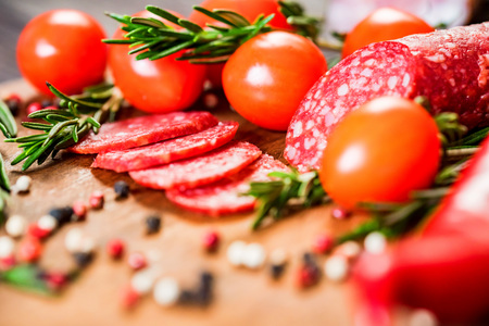 Tasty salami with tomatoes and peppercorn closeの写真素材