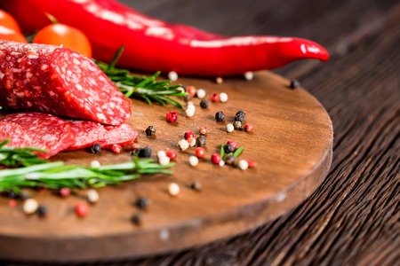Tasty salami with tomatoes and peppercorn closeの写真素材