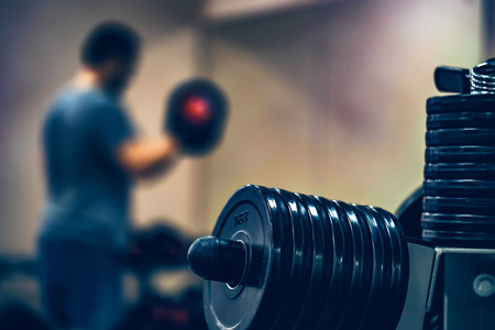 Barbell and weight plates with trainning manの写真素材