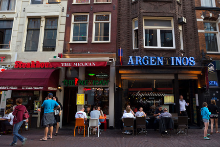 AMSTERDAM, THE NETHERLANDS - JUNE 10, 2014: Beautiful sreets of Amsterdam with outdoors cafe on summer dayのeditorial素材