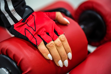 Womans hand touches gym machineの写真素材