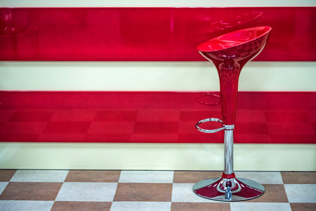 Red plastic bar stool near counterの写真素材