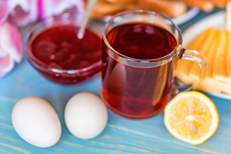 Breakfast with tea, jam and flowersの写真素材