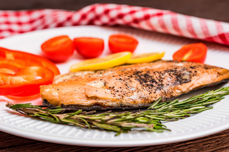 Salmon steak with vegetables close upの写真素材
