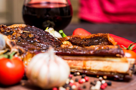 Beef steak with spices, vegetables and wine closeの写真素材