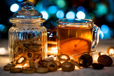 Cozy still life of tea, christmas light and pastryの写真素材