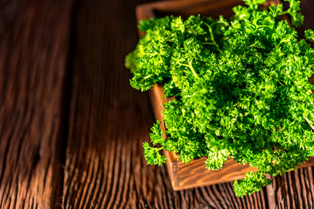 Parsley in wooden box on wooden background closeの写真素材
