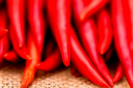 Red chili peppers on beige canvas clothの写真素材