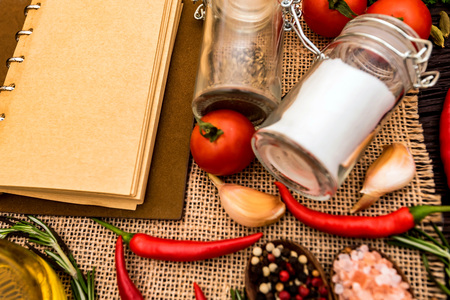 Open cook book and various spices compositionの写真素材