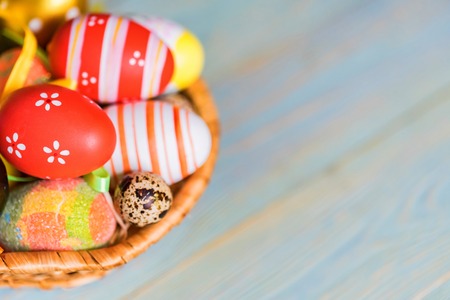 Several colorful Easter eggs in basket closeの写真素材