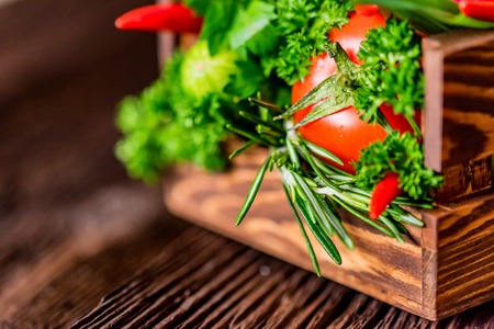Fresh vegetables and herbs in wooden boxの写真素材