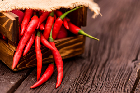 Red chili peppers wooden box closeの写真素材