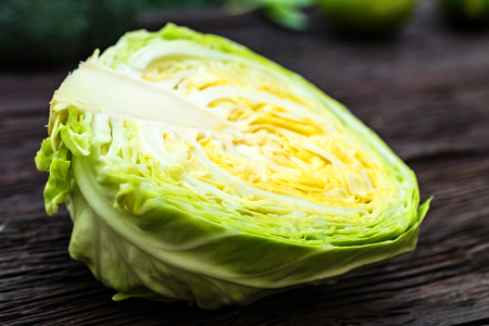 Half of fresh cabbage head on wooden surfaceの写真素材