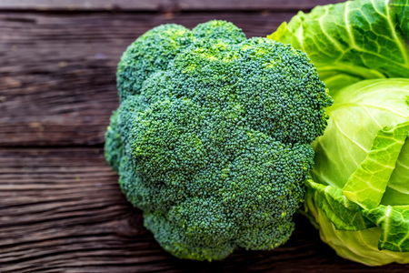 Green fresh broccoli and cabbage on wooden surfaceの写真素材