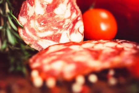 Tasty salami with tomatoes and peppercorn closeの写真素材